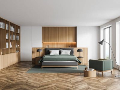 Stylish modern interior of contemporary bedroom with comfortable furniture. Bed for two with blanket and pillows, armchair and bookshelf. Wooden parquet floor. Big windows. 3d rendering.
